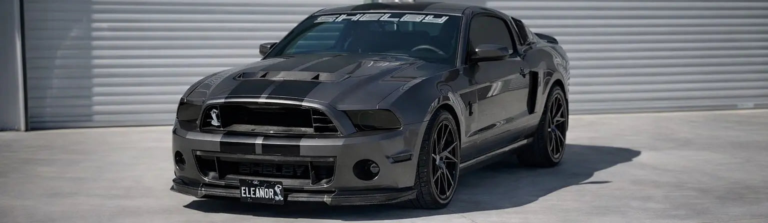 Black Mustang car with 'Legacy Motorsports' branding on a concrete surface.